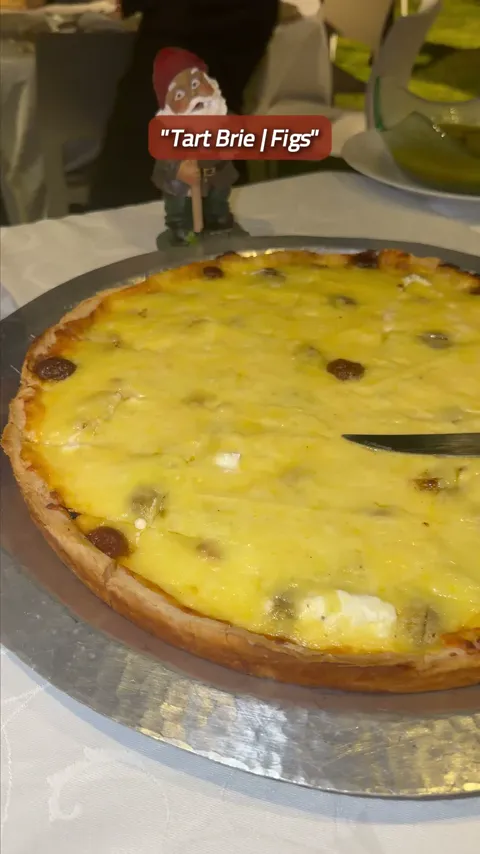 Our chefs finishing a warm brie and fig tart for a buffet.