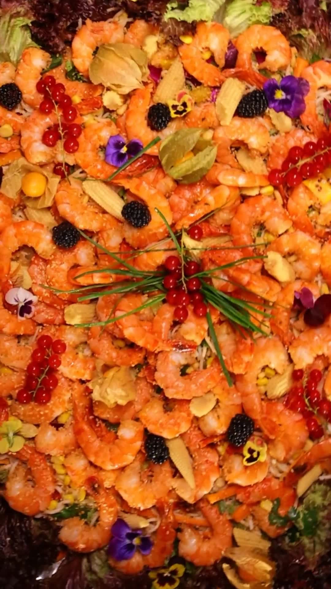 Platter of prawns garnished with herbs and edible flowers at an Alam Catering event in Lebanon